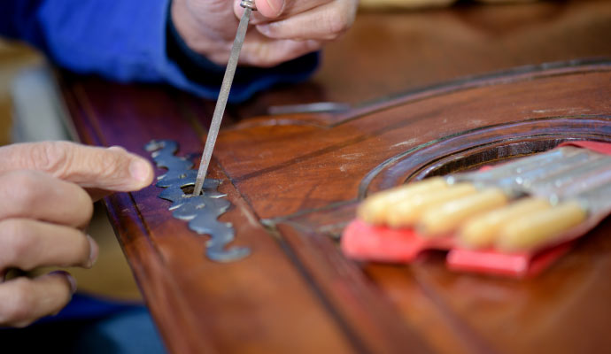 professional worker restoring an antique art-work