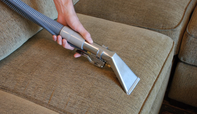 professional worker cleaning upholstery