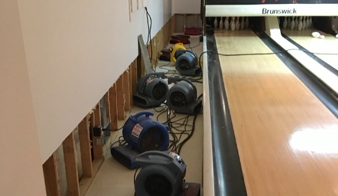 water dehumidifier is in operation to dry out the bowling alley