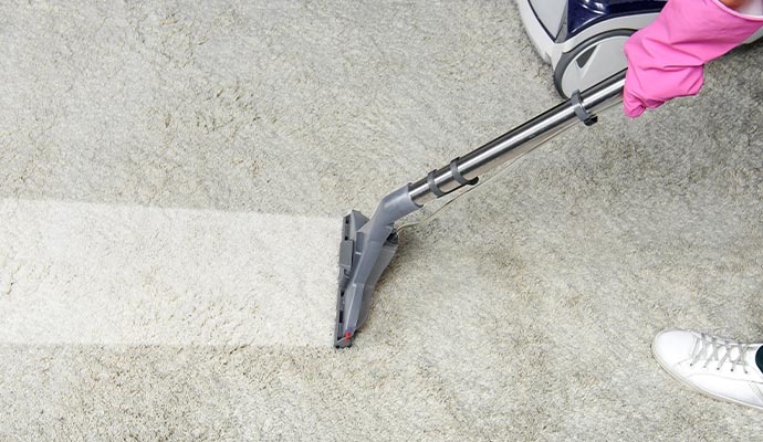 person carpet cleaning with cleaning machine